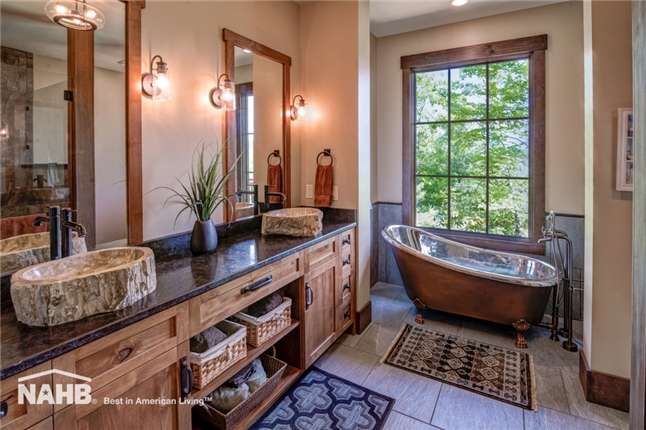 Gorgeous bath with custom double sink fixture and copper and crome lined clawfoot tub. Image courtesy NAHB Best in American Living.