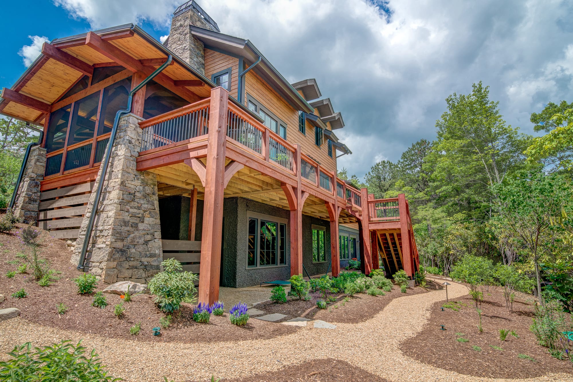 Pritchard-Hardin rear exterior with enormous second floor deck overlooking newly planted and manacured garden with scenic mountain view. Image courtesy NAHB Best in American Living.